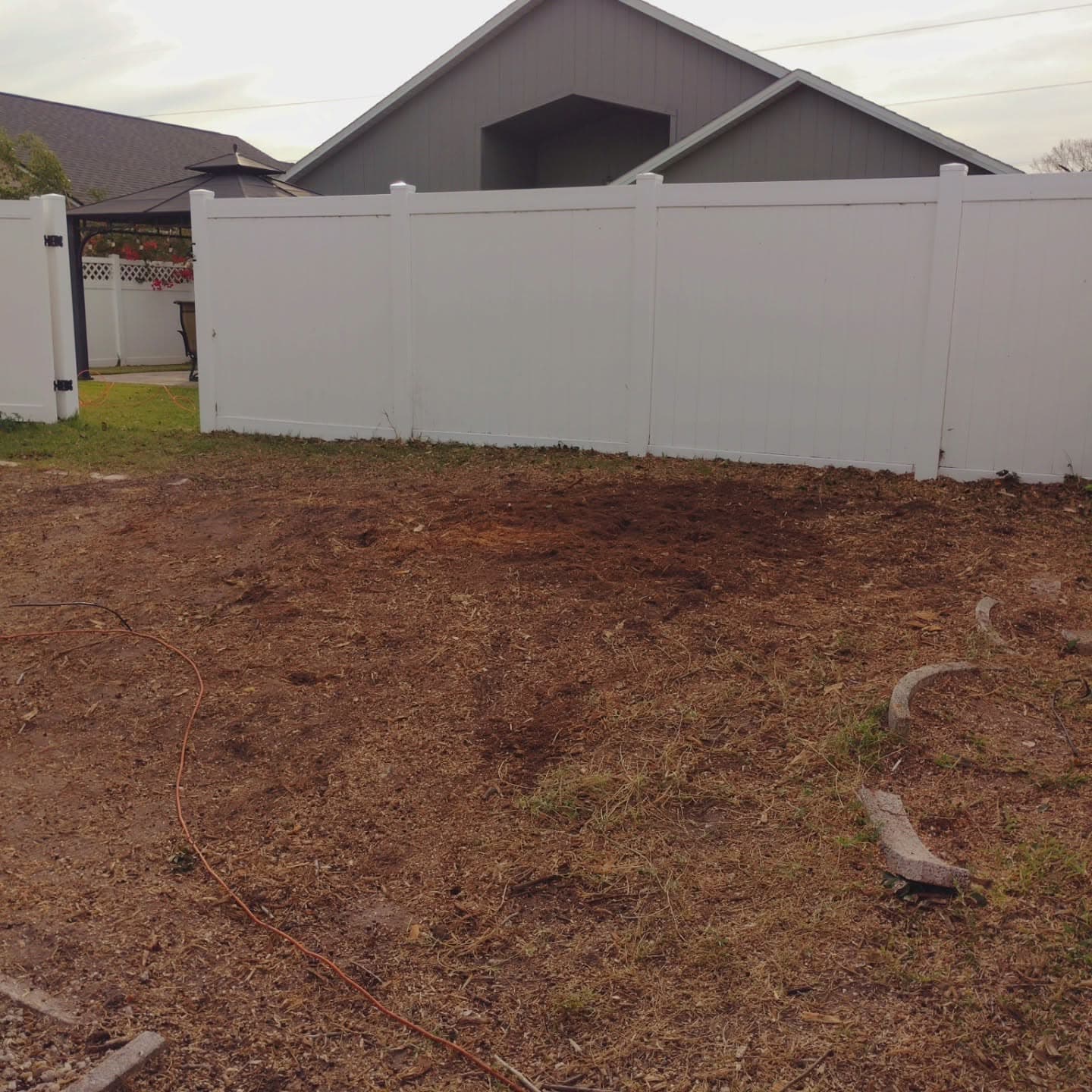 Stump ground below grade, yard back